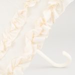 Elegant ivory wedding umbrella with double frilled design for special occasions.