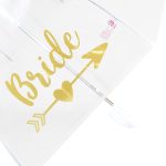 Clear umbrella with gold 'Bride' text and arrow design for wedding accessories.