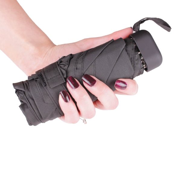 Black mini umbrella held in hand, compact and portable design.